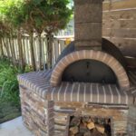 Outdoor Stone Kitchen With Large Firebrick Pizza Oven and Large Rotisserie bbq