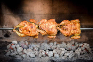 Outdoor Stone Kitchen With Firebrick Pizza Oven and Large Rotisserie bbq